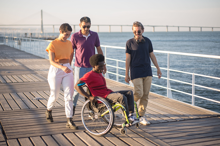 A group of friends walking together along a boardwalk